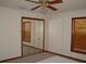 Bright bedroom with mirrored closet doors, neutral walls, wood trim, and a glimpse of a bed at 11624 Delmar Ave, Orlando, FL 32836