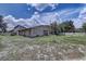 View of the home exterior with spacious yard and ample greenery at 11624 Delmar Ave, Orlando, FL 32836