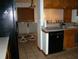 The kitchen flows into the dining area, showcasing tile flooring and a black dishwasher at 11624 Delmar Ave, Orlando, FL 32836