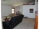 Open concept living room and dining area featuring neutral carpeting and classic furniture pieces at 11624 Delmar Ave, Orlando, FL 32836
