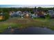 Aerial image capturing a home's screened-in porch and a serene pond, perfect for relaxing outdoors at 12543 Waterhaven Cir, Orlando, FL 32828