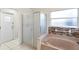 Bathroom featuring a bathtub, a walk-in shower, and tiled floors at 12543 Waterhaven Cir, Orlando, FL 32828