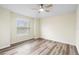 Bedroom featuring neutral paint, modern floors, a ceiling fan, and a window at 12543 Waterhaven Cir, Orlando, FL 32828