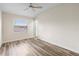 Bedroom featuring neutral paint, modern floors, a ceiling fan, and a window at 12543 Waterhaven Cir, Orlando, FL 32828