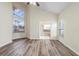 Bright bedroom featuring hardwood floors, high ceilings, and an ensuite bathroom at 12543 Waterhaven Cir, Orlando, FL 32828