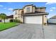Two-story home featuring a well-manicured lawn, a two-car garage, and a neutral-colored facade at 12543 Waterhaven Cir, Orlando, FL 32828