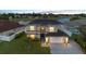 An exterior shot of a well-kept two-story home featuring a two-car garage and lovely lawn at 12543 Waterhaven Cir, Orlando, FL 32828