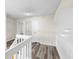 Upstairs hallway with modern floors and neutral paint leading to various rooms at 12543 Waterhaven Cir, Orlando, FL 32828