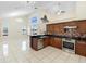 Open-concept kitchen and living room featuring tile floors, granite counters, and stainless steel appliances at 12543 Waterhaven Cir, Orlando, FL 32828