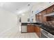 Open-concept kitchen featuring tile floors, granite counters, and stainless steel appliances at 12543 Waterhaven Cir, Orlando, FL 32828
