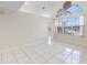 Spacious living room featuring tile floors, large windows, and soaring vaulted ceilings at 12543 Waterhaven Cir, Orlando, FL 32828