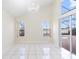 Bright living room featuring tile floors, access to the lanai, and large windows overlooking the pool at 12543 Waterhaven Cir, Orlando, FL 32828