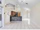 Open-concept living room featuring tile floors, a mosaic wet-bar, and an elegant chandelier at 12543 Waterhaven Cir, Orlando, FL 32828