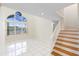 Bright living room with tile floors, staircase, and large windows overlooking the pool at 12543 Waterhaven Cir, Orlando, FL 32828