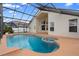 Beautiful screened-in pool with a spa and lovely tile work providing a wonderful place to relax and unwind at 12543 Waterhaven Cir, Orlando, FL 32828