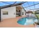 Inviting screened-in pool with a spa and tan surface offers an ideal outdoor leisure and entertaining space at 12543 Waterhaven Cir, Orlando, FL 32828