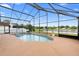 Serene screened-in pool and spa area with views of a tranquil pond providing a perfect outdoor oasis at 12543 Waterhaven Cir, Orlando, FL 32828