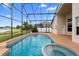 Lovely screened-in pool with a spa and lush surroundings creating a relaxing space for enjoying Florida living at 12543 Waterhaven Cir, Orlando, FL 32828