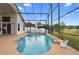 Relaxing screened-in pool and spa area with views to the golf course and beyond, perfect for outdoor enjoyment at 12543 Waterhaven Cir, Orlando, FL 32828