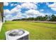 Large, grassy backyard with a white fence and tree line at 1312 Sugarwood St, Davenport, FL 33837