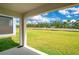 View of the covered porch and spacious green backyard at 1312 Sugarwood St, Davenport, FL 33837