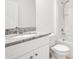 Bathroom featuring white cabinet and granite countertop, shower and toilet at 1312 Sugarwood St, Davenport, FL 33837