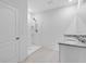 Bright bathroom featuring granite counters, double sinks, and a walk-in shower at 1312 Sugarwood St, Davenport, FL 33837
