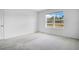 Bright bedroom with carpeted floors, large windows, and neutral walls at 1312 Sugarwood St, Davenport, FL 33837