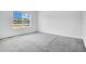Bright bedroom with carpeted floors, a large window, and neutral walls at 1312 Sugarwood St, Davenport, FL 33837