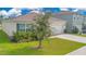Single-story home with a well-manicured lawn and an attached two-car garage at 1312 Sugarwood St, Davenport, FL 33837