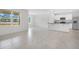 Open-concept living space with tile flooring, natural light, and a kitchen with an island at 1312 Sugarwood St, Davenport, FL 33837