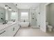 Modern bathroom with a double vanity, soaking tub, glass-enclosed shower, and sleek fixtures at 13254 Sw 30Th Terrace Rd, Ocala, FL 34473