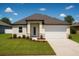 Charming one-story home featuring a well-manicured lawn, two-car garage, and a welcoming entrance at 13254 Sw 30Th Terrace Rd, Ocala, FL 34473