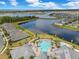 An aerial view of a community pool and lakefront homes in a well-planned community with blue skies at 13330 Panama Beach Ct, Orlando, FL 32827