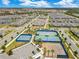 Beautiful aerial of community sports courts including tennis and basketball courts, surrounded by lush landscaping at 13330 Panama Beach Ct, Orlando, FL 32827