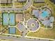 Aerial view of a community clubhouse with a pool, tennis courts, a basketball court and a playground at 13330 Panama Beach Ct, Orlando, FL 32827