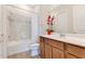 Bathroom featuring a shower-tub combo, white vanity, and decorative accents at 13330 Panama Beach Ct, Orlando, FL 32827