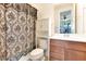 Bathroom featuring a toilet, vanity with modern fixtures, and tub with a decorative shower curtain at 13330 Panama Beach Ct, Orlando, FL 32827