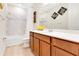 Well-lit bathroom featuring a wood vanity with a solid surface counter and a tiled shower-tub combination at 13330 Panama Beach Ct, Orlando, FL 32827