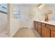 Bathroom showcasing a double vanity with a white countertop and a tiled shower at 13330 Panama Beach Ct, Orlando, FL 32827