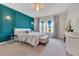 A beautifully staged bedroom with decorative wall moldings, a chandelier and large windows at 13330 Panama Beach Ct, Orlando, FL 32827