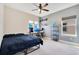Modern bedroom featuring a ceiling fan, desk with computer, and decorative shiplap accent wall at 13330 Panama Beach Ct, Orlando, FL 32827