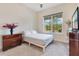 Bright bedroom with gray carpet, queen bed, dresser, and large window at 13330 Panama Beach Ct, Orlando, FL 32827