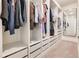 A well organized walk-in closet with ample shelf and drawer space and full length mirror at 13330 Panama Beach Ct, Orlando, FL 32827