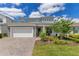 Charming two-story home with a brick driveway, well-manicured lawn and stone veneer details at 13330 Panama Beach Ct, Orlando, FL 32827