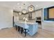 Stylish kitchen with an island, pendant lights, and modern appliances, offering ample space for cooking and entertaining at 13330 Panama Beach Ct, Orlando, FL 32827