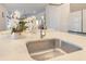 Close-up of a kitchen island featuring a modern sink, stylish faucet, and elegant countertop decor at 13330 Panama Beach Ct, Orlando, FL 32827