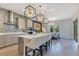 Spacious kitchen featuring a large island, stainless steel appliances, and a cozy dining area at 13330 Panama Beach Ct, Orlando, FL 32827