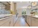Bright, updated kitchen features sleek gray cabinets, modern appliances, tile backsplash, and an eat-in dining space at 13330 Panama Beach Ct, Orlando, FL 32827