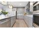 Contemporary kitchen showcases gray cabinetry, stainless steel appliances, and mosaic backsplash for a modern design at 13330 Panama Beach Ct, Orlando, FL 32827